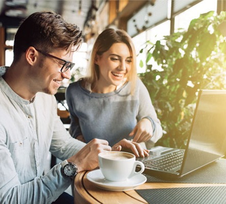 Couple looking at a laptop together.